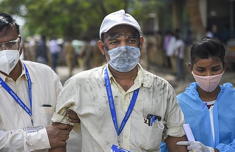 Health workers evacuate employees of Vijay Vallabh COVID care hospital after a fire in Virar West. (Photo | PTI)
