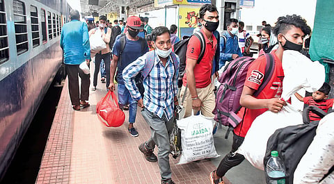 Migrant workers rushing to board a train to their native at the Coimbatore railway station | U Rak esh Kumar