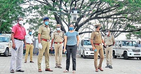 DCP Aishwarya Dongre, other officers monitor the drone camera-aid patrolling, launched to nab those who flout face mask and social distancing norms across Kochi, on Sunday (Photo | A Sanesh, EPS)