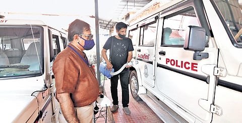 Antony and Aslam sanitise vehicles at Kochi city traffic enforcement unit west on Sunday. (Photo | Arun Angela, EPS)