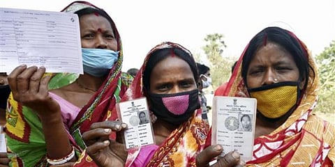 Women show their voter identity cards in West Bengal. (Photo | PTI)