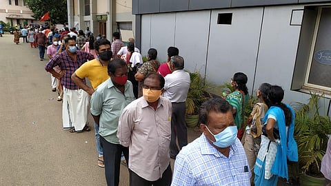 People waiting in a queue for the COVID-19 vaccination at Jimmy George Indoor stadium in Thiruvananthapuram (Express Photo | BP Deepu)