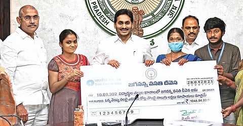 Chief Minister YS Jagan Mohan Reddy handing over Jagananna Vasathi Deevena benefits to selected students at his camp office in Tadepalli on Wednesday | Express