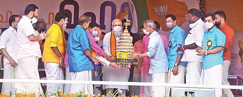 BJP Palakkad district chief E Krishnadas hands over a replica of a decorated chariot to PM Modi | FIle pic