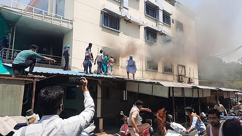 Patients try to jump from the burning floors of the Ujjain hospital on Sunday. (Photo | Express)