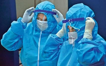 Health workers in PPE kits. (Photo| PTI)