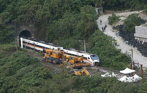 Rescue workers remove a part of the derailed train near Taroko Gorge in Hualien, Taiwan . (Photo | AP)