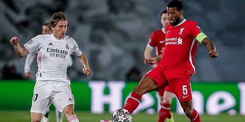 Liverpool's Georginio Wijnaldum (R) controls the ball next to Real Madrid's Luka Modric during the Champions League quarterfinalclash. (Photo | AP)