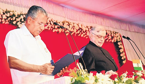 Governor P Sathasivam administers the oath of office to Pinarayi Vijayan, the new chief minister of Kerala, during the swearing-in ceremony on May 25, 2016