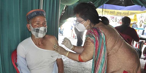 A health worker administers COVID-19 vaccine to a citizen during an inoculation drive. (Photo | PTI)