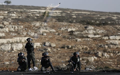 Israeli troops fire teargas as they clash with Palestinians