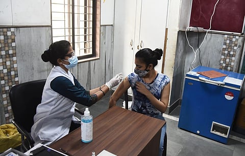 A beneficiary above 18 years old gets the COVID-19 vaccine, at a government school (COVID-19 Centre) in New Delhi on Tuesday. (Photo | Parveen Negi, EPS)