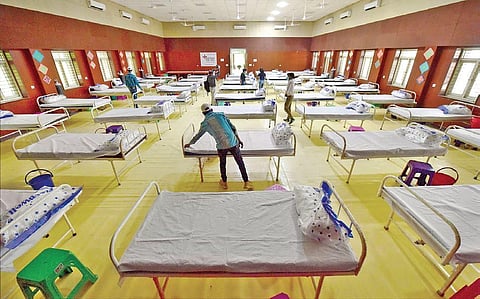 Workers prepare beds at a Covid care centre. (Representational Photo | PTI)