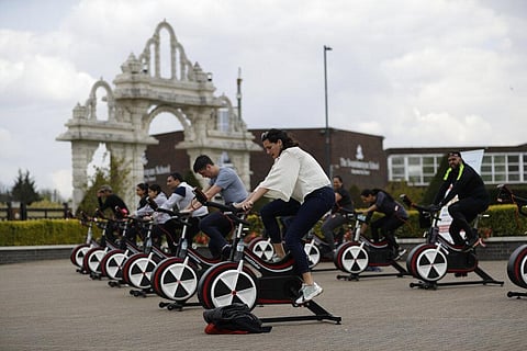 People take part in 'Cycle to Save Lives' a 48 hour, non-stop static relay cycle challenge at the BAPS Shri Swaminarayan Mandir (Photo | AP)