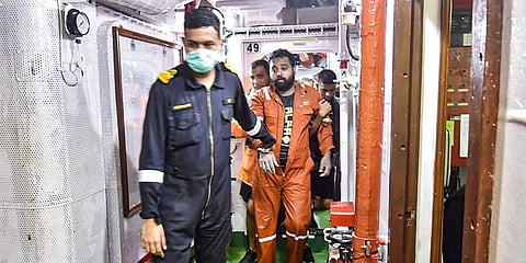 Rescued crew members of the barge P305, being brought at an Indian Naval Ship off the Mumbai coast. (Photo | PTI)