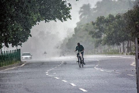 A cyclist braves thundershower in Bhubaneswar on Friday | Express