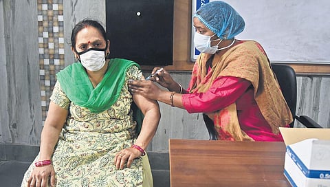 A health worker gives Covid vaccine to a woman in New Delhi. (Photo | Parveen Negi, EPS)