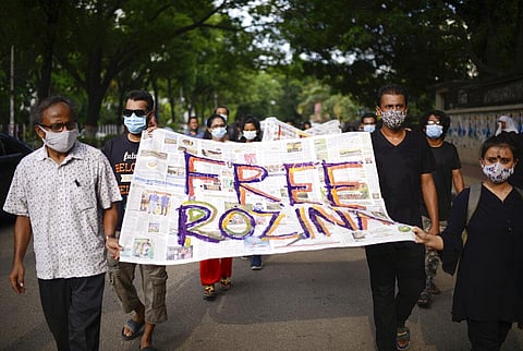 Bangladeshi artists carry an artwork during a protest against the arrest of Rozina Islam in Dhaka. (Photo | AP)