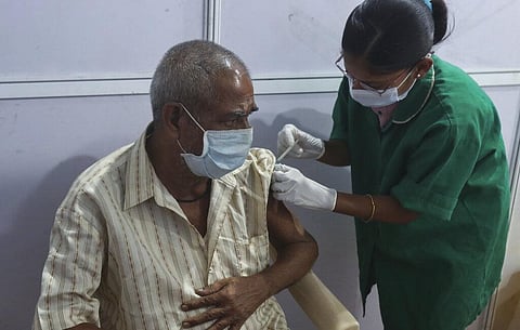 A health worker administers covid vaccine (Photo | AP)