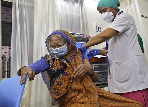 An elderly woman reacts as she receives a dose of COVAXIN vaccine for COVID-19 at a vaccination centre in Mumbai. (Photo | AP)