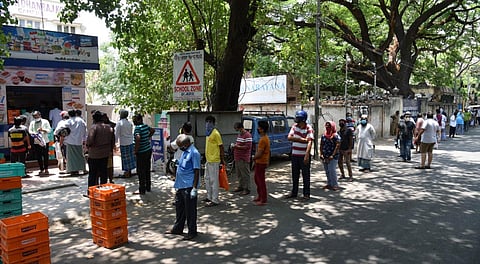 People queue to buy milk at Aavin before the total lockdown at Vepery in Chennai on Saturday. (Photo | R Sathish Babu/EPS)