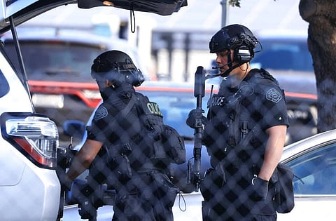 Law enforcement officers get gear from their trunk near the scene of a shooting in San Jose, California (Photo | AP)