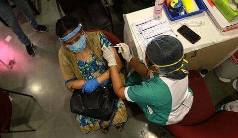 A beneficiary receives a dose of the COVID-19 vaccine during a vaccination drive in New Delhi on Thursday. (Photo | Shekhar Yadav/EPS)