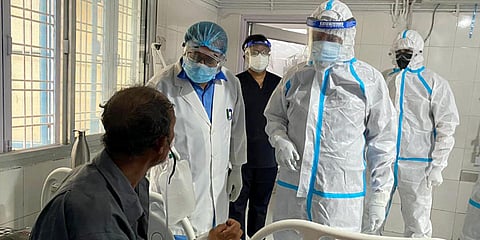 Uttarakhand Chief Minister Tirath Singh Rawat in PPE kit meets Covid patients at a district hospital in Uttarkashi. (Photo| ANI)