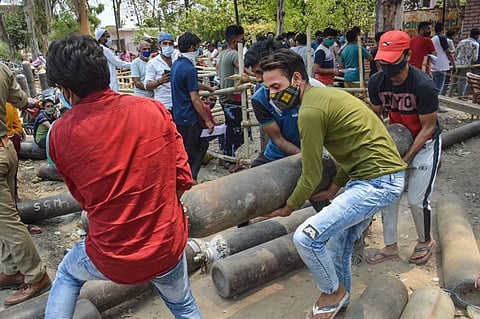 Attendees of a COVID-19 patient carry an oxygen cylinder after refilling, in Meerut, Thursday, May 6, 2021. (Photo | PTI)