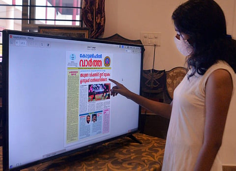 A student reading an e-paper of Government Cotton Hill HSS in an online class at the school office in Thiruvananthapuram. (Photo | EPS/Vincent Pulickal)