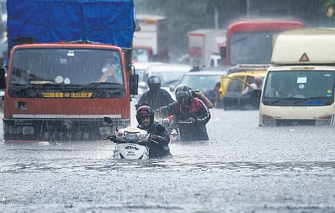 Vehicles make their way through a waterlogged road during heavy rain, at Kings Circle, in Mumbai. (Photo | PTI)
