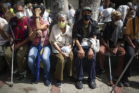 Seniors sit waiting to be vaccinated during a COVID-19 vaccination drive for seniors and those considered high risk for contagion in Venezuela. (Photo | AP)