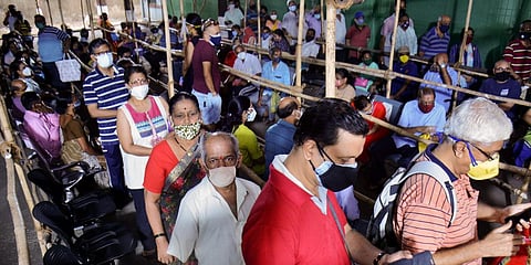Citizens stand in a queue at Thane Nurses Training Vaccination Center to receive a dose of COVID-19 vaccine, in Thane. (File photo | PTI )