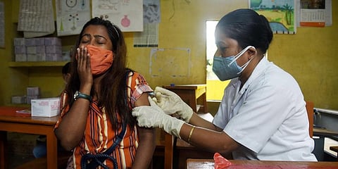 A medic administers a dose of COVID-19 vaccine to a young person at a vaccination centre in Guwahati, Saturday, June 12, 2021. (Photo | PTI)