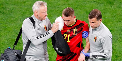 Belgium's Timothy Castagne is treated for injury during the Euro 2020 championship match against Russia. (Photo | AP)