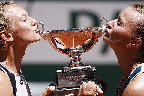 Czech Republic's Barbora Krejcikova, right, and compatriot Katerina Siniakova kiss the cup after winning the women's doubles final match in French Open. (