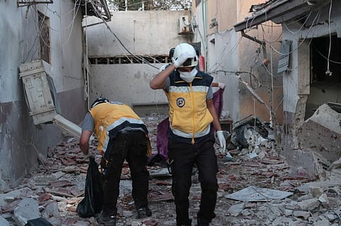 Members of Syria's Civil Defence service (White Helmets) sift through the rubble at Al-Shifaa hospital following shelling of the rebel-held city of Afrin in northern Syria, on June 12. (Photo | AFP)