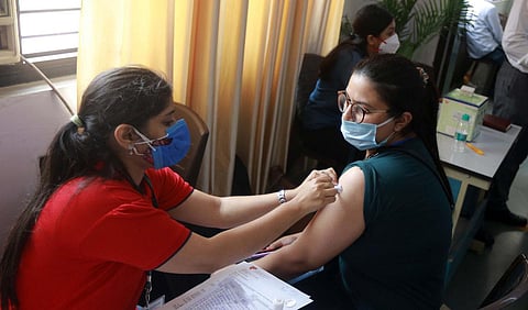 A health worker administers COVID-19 vaccine dose to a student at a vaccination centre organised for the students travelling abroad for higher studies, in New Delhi.