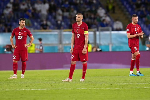 From left, Turkey's Kaan Ayhan, Burak Yilmaz and Merih Demiral react after Italy's Lorenzo Insigne scored his side's third goal. (Photo | AP)