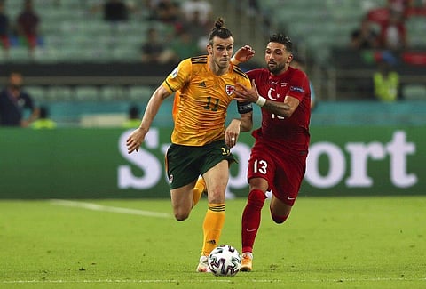 Wales' Gareth Bale, left, runs with the ball as he is challenges by Turkey's Umut Meras during the Euro 2020 soccer championship group A match between Turkey and Wales. (Photo | AP)