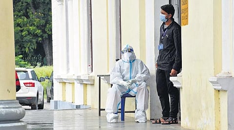 Health workers wait for patients at a Covid-19 testing booth on a rainy Wednesday in Mysuru | udayshankar s