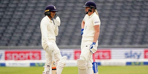 England's Sophie Ecclestone (L) and Sophia Dunkley speak, during day two of the Women's International Test cricket match between England and India, at the Bristol County Ground. (Photo | AP)
