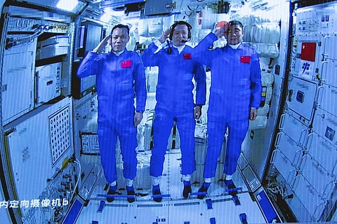 In this photo released by Xinhua News Agency, Chinese astronauts salute after successfully entering the Tianhe space station module. (Photo | AP)
