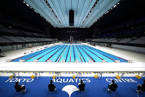 Tokyo 2020 Olympic Games Organizing staff prepare a Paralympic swimming test event at the Tokyo Aquatics Center. (Photo | AP)