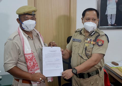 Director General of Police, Bhaskar Jyoti Mahanta with Home Guard Borsing Bey while felicitating him on Wednesday. (Photo | Twitter)