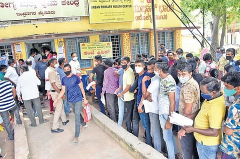 People wait to get inoculated outside a Covid-19 vaccination centre in Mysuru on Wednesday | Udayshankar S