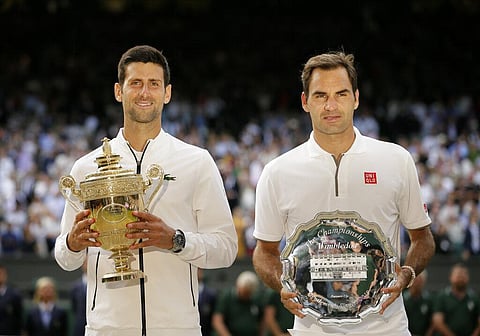Serbia's Novak Djokovic, left, and Switzerland's Roger Federer pose with the trophies after the men's singles final match of the Wimbledon Tennis Championships (Photo | AP)