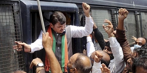 Police detains former Maharashtra CM Devendra Fadnavis during a 'Chakka Jam' protest over the OBC reservation issue, in Nagpur. (Photo | PTI)