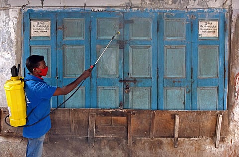 A corporation worker sanitize shop due to Lockdown relaxations, at Connemera market, Pudupet, in Chennai. (Photo | R Satish Babu, EPS)