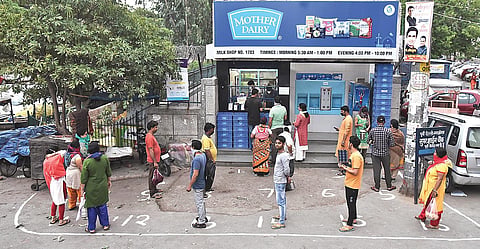People stand in a queue outside a Mother dairy booth while maintaining social distancing. (File Photo | Parveen Negi, EPS)